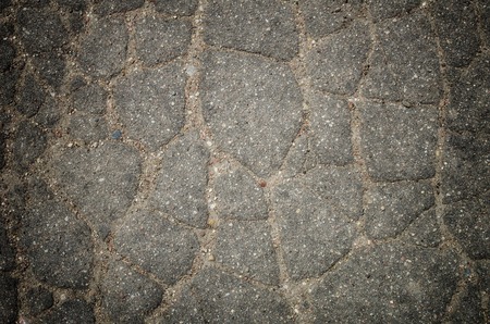 Old asphalt textured crashed road, close upの写真素材