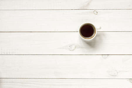 Coffee cup on wood table top view with copy spaceの写真素材