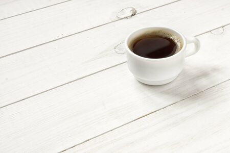 Hot coffee cup on white wood table.の写真素材
