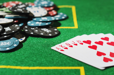 Five poker cards with chips on green table. Win card set