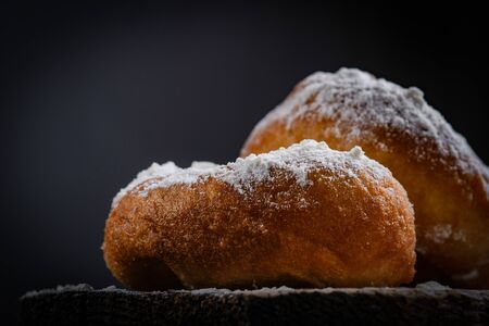 Tradition Jewish holiday sweets, donut sufganiyot with sugar powder and jam.