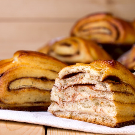 Bun with Cinnamon on Wooden Background