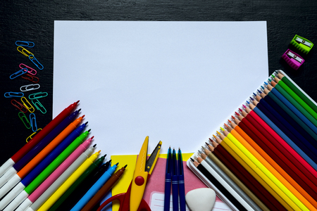 School supplies on a black background. Top view
