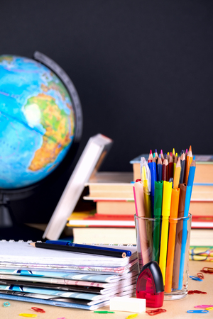 School supplies on blackboard background with copy spaceの写真素材
