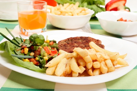 French fries, salad and chopの写真素材