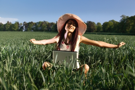 Young woman working with a laptop outdoorの写真素材