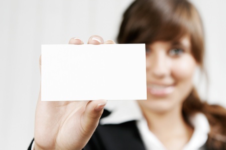 Smiling woman holding an empty cardの写真素材