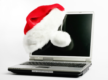 Christmas laptop with red santa hat の写真素材