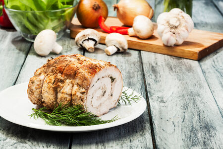 Pork lion roll stuffed with mushrooms on a plate の写真素材