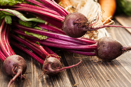 Beetroots, carrots and leek on a wooden table