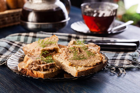 Slices of bread with baked pate on plateの写真素材