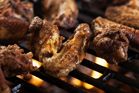 Grilling chicken wings on barbecue grill. Selective focusの写真素材