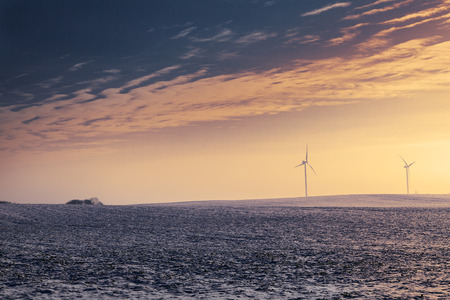 Modern wind turbines during wintertime on sunset
