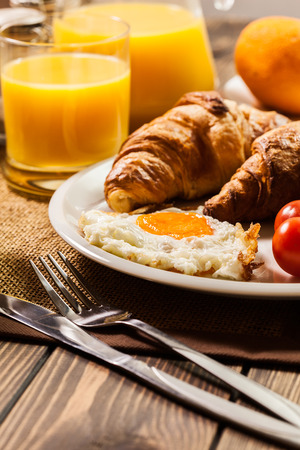 Breakfast with croissant orange juice eggs endの写真素材