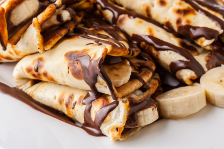 Traditional crepes with banana and chocolate creamの写真素材