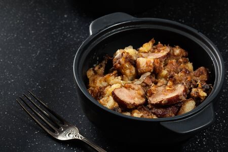 Potatoes baked with sausage and bacon.の写真素材
