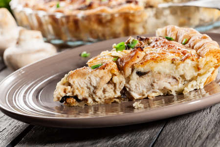 Slice of tart with chicken, mushrooms and cheeseの写真素材