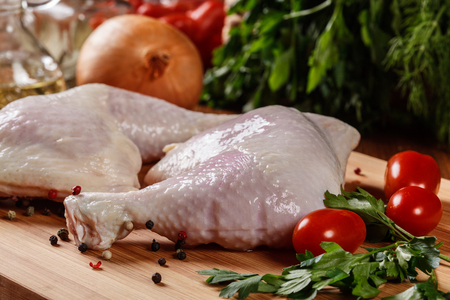 Raw chicken legs and marinade ingredients on the cutting boardの写真素材