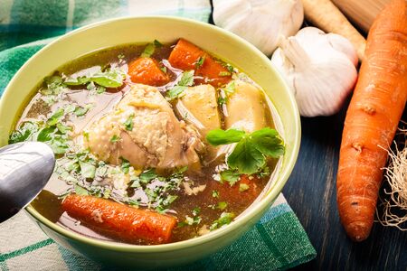 Fresh chicken broth with noodles and carrotの写真素材