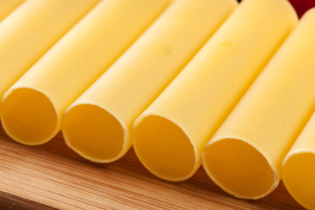 Uncooked cannelloni pasta on cutting board and ingredients. Italian cuisineの写真素材