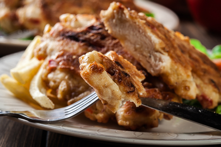Close up of chicken medallions piece served with chips and salad.の写真素材