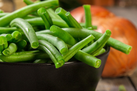 Raw green beans in a black dish. Healthy food