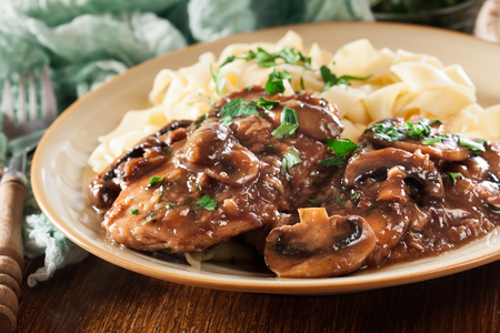 Delicious chicken marsala served with fettucine pasta. Italian cuisineの写真素材