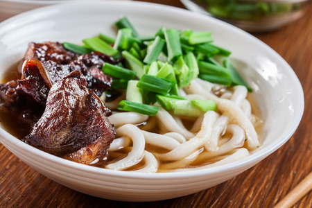Japanese Udon noodles with beef, green onion and soup in a dishの写真素材