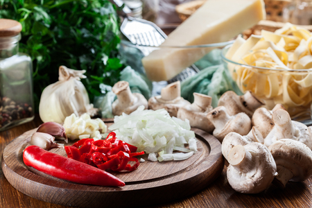Ingredients ready for prepare tagliatelle pasta with champignon in mushroom gravyの写真素材