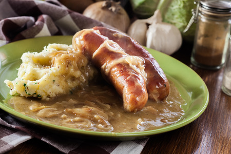 Bangers and Mash. Baked sausage in onion gravy served with mashed potatoesの写真素材