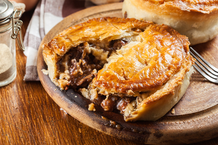 Fresh beef stew pie on a cutting board. Meat in puff pastryの写真素材