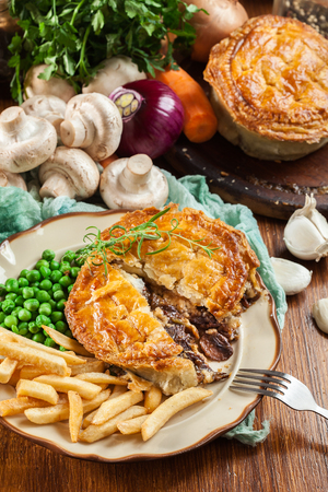 Homemade beef stew pie with french fries. Meat in puff pastry. Top viewの写真素材