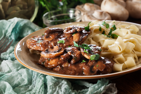 Delicious chicken marsala served with fettucine pasta. Italian cuisineの写真素材