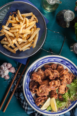 Crispy chicken karaage with lettuce. Popular japanese dish. Top viewの写真素材