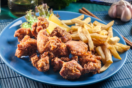 Crispy chicken karaage served with french fries. Popular japanese dishの写真素材