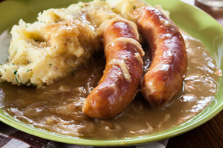 Bangers and Mash. Baked sausage in onion gravy served with mashed potatoesの写真素材