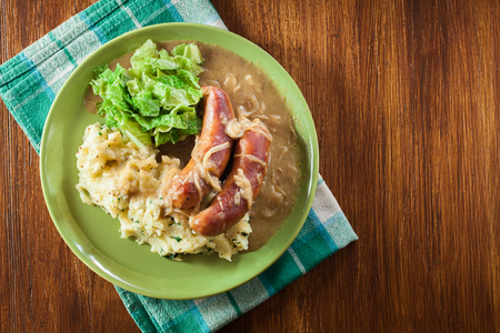 Bangers and Mash. Baked sausage in onion gravy served with mashed potatoes and cabbage. Top viewの写真素材