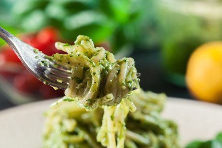 Close-up of pasta spaghetti with homemade basil pesto sauce on white plate. Top viewの写真素材