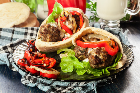 Tasty kofta kebab with grilled paprika and onion served on pita flatbreadの写真素材