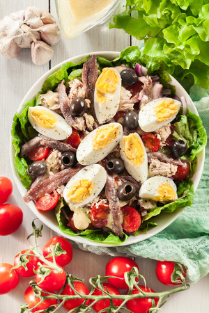 Nicoise Salad with tuna, anchovy, eggs and tomatoes. French dishの写真素材