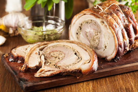 Traditional italian porchetta. Rolled pork belly stuffed with mincemeat and herbs.