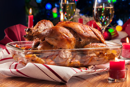Baked or roasted whole chicken on Christmas table. Xmas dinnerの写真素材
