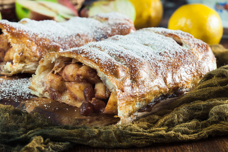 Traditional puff pastry strudel with apple, raisins and cinnamonの写真素材