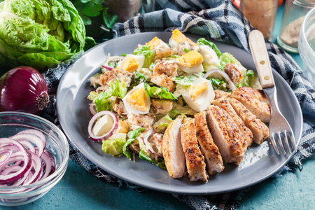Healthy caesar salad with chicken, eggs, cheese and croutons. Italian cuisineの写真素材