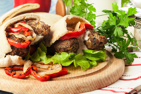 Tasty kofta kebab with grilled paprika and onion served on pita flatbreadの写真素材
