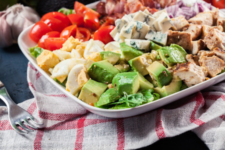 Healthy cobb salad with chicken, avocado, bacon, tomato, and eggs. American dishの写真素材