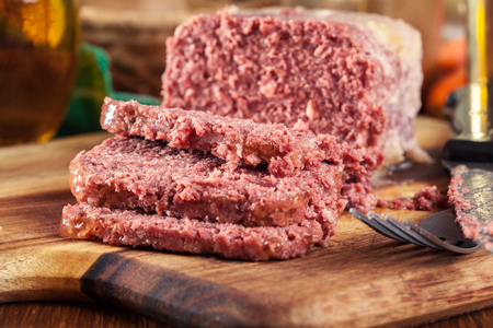 Delicious sliced corned beef on cutting boardの写真素材