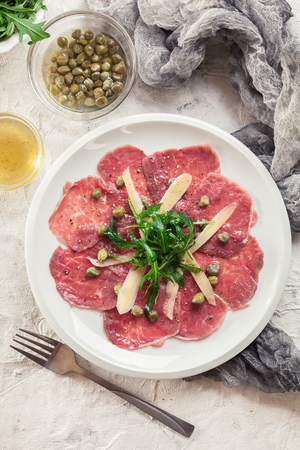Beef carpaccio with arugula and parmesan. Italian dishの写真素材