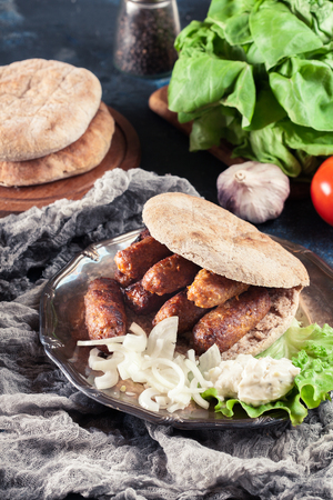 Cevapcici or cevapi served with lepinja bread and onion. Popular dish all over the Balkansの写真素材
