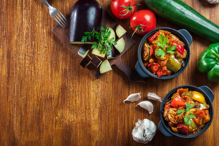 Ratatouille, delicious vegetarian stew. Dish made of zucchini, eggplant, bell peppers, onions, garlic and tomatoes. Traditional french foodの写真素材